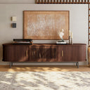 Wooden entertainment console with decorative items in a living room setting