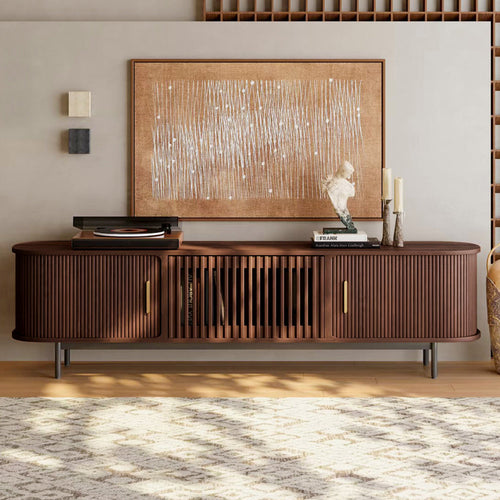 Wooden entertainment console with decorative items in a living room setting