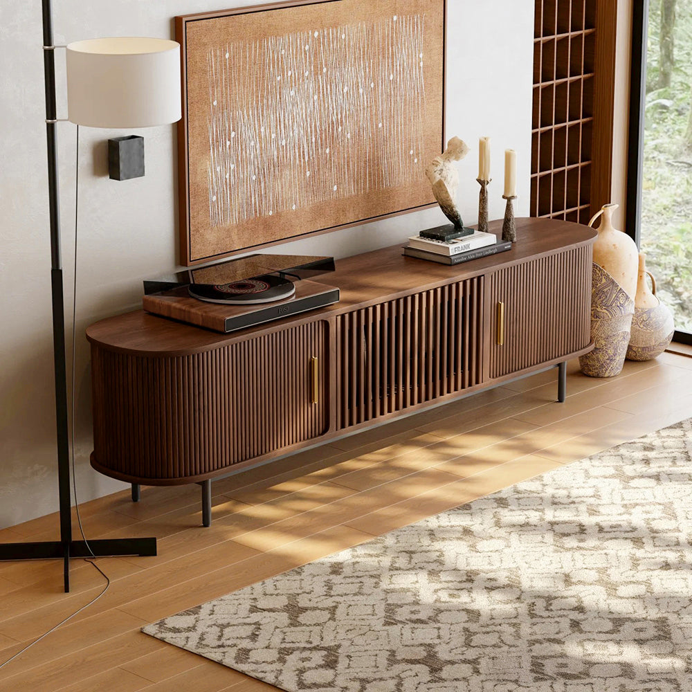 Wooden entertainment console with decorative items in a living room setting