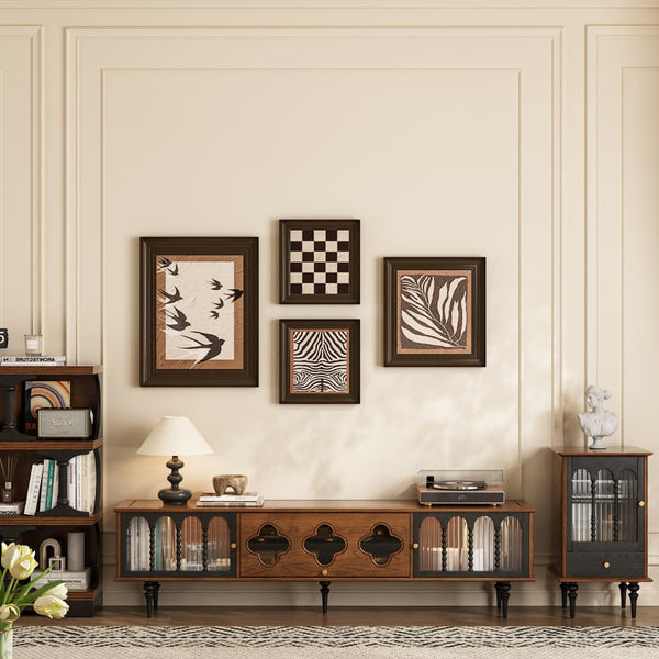 Living room with wooden furniture, decorative wall art, and a lamp.